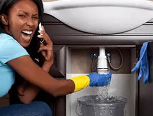 Emergency plumbing repair for a leaking sink drain under a bathroom vanity in Modesto, CA