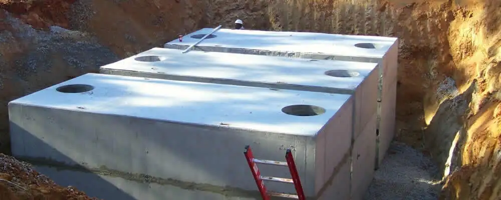 Septic tank installation site with a newly placed concrete tank in Modesto, CA